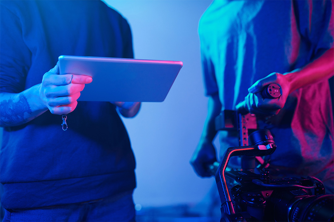 Filmmaker holding tablet with camera rig visible, showing agile production.