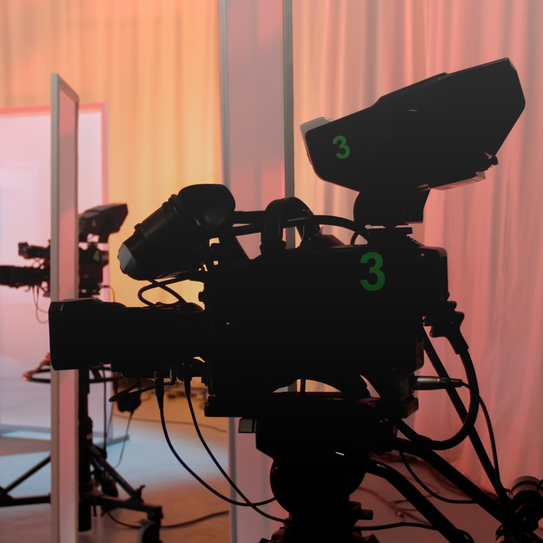 Professional film camera setup on a soundstage with warm lighting, capturing the atmosphere of a movie production in progress.
