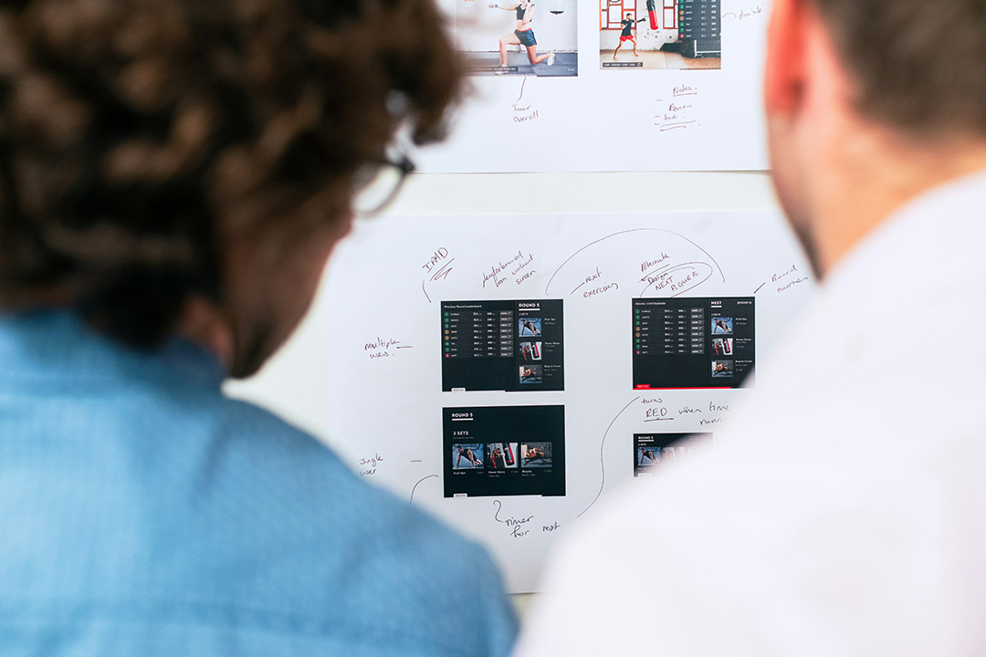 Team of marketers reviewing campaign dashboards and analytics, highlighting the role of AdTech in measuring performance and refining strategies.