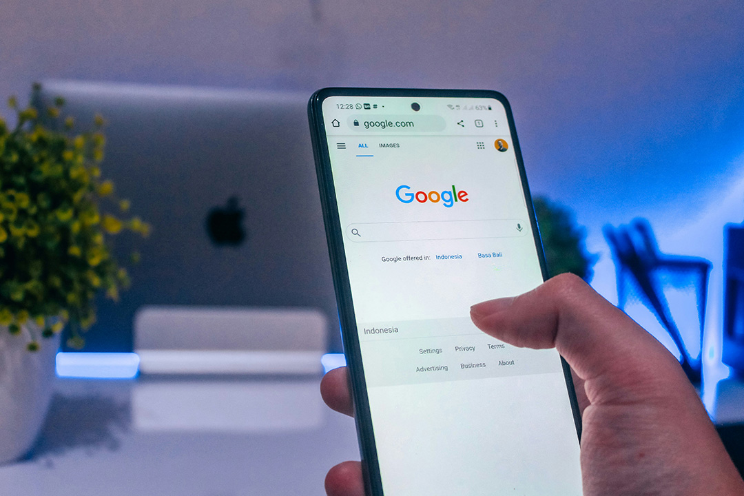Person holding a smartphone with the Google search page open, highlighting how Dynamic Search Ads connect searches to relevant content.