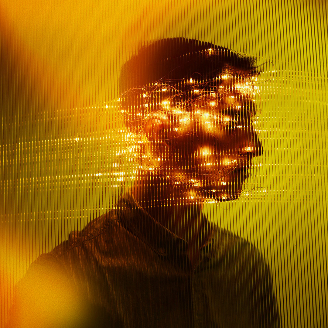 Human silhouette with glowing golden light patterns overlaying the head, symbolizing the balance of human judgment and automation in digital advertising campaigns.
