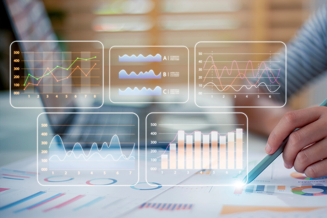 A digital interface displaying analytics dashboards with graphs and charts overlays, representing ad engagement metrics and customer retention trends. A person is seen analyzing data on paper while using a digital pen, symbolizing the importance of data-driven decision-making in reducing customer churn.